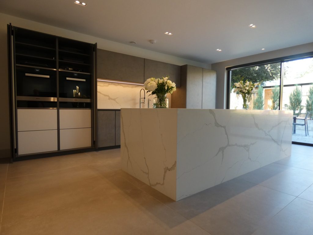 Kitchen featuring large white marble island and worktop